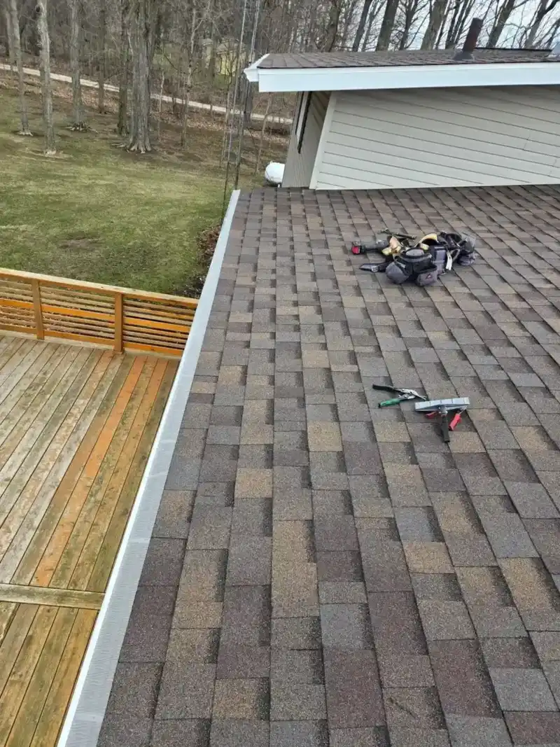 Newly installed designer asphalt shingle roof on a country home