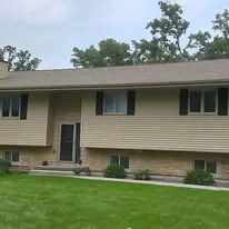 Wisconsin tan-sided ranch home with a newly installed architectural shingle roof