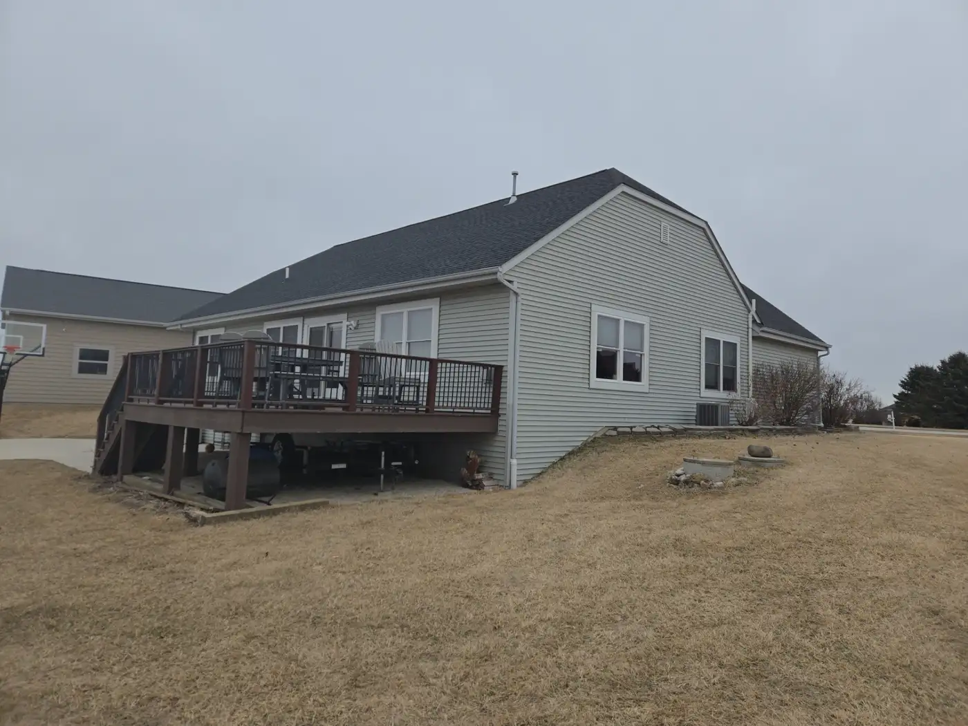 Before side and rear view of a Richfield Wisconsin home with original light siding before renovation