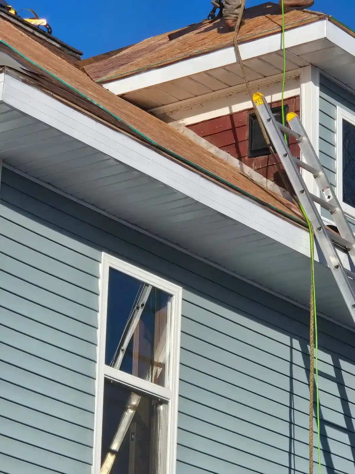 Close-up of roof prep work and deck exposure on a steep Wisconsin reroof