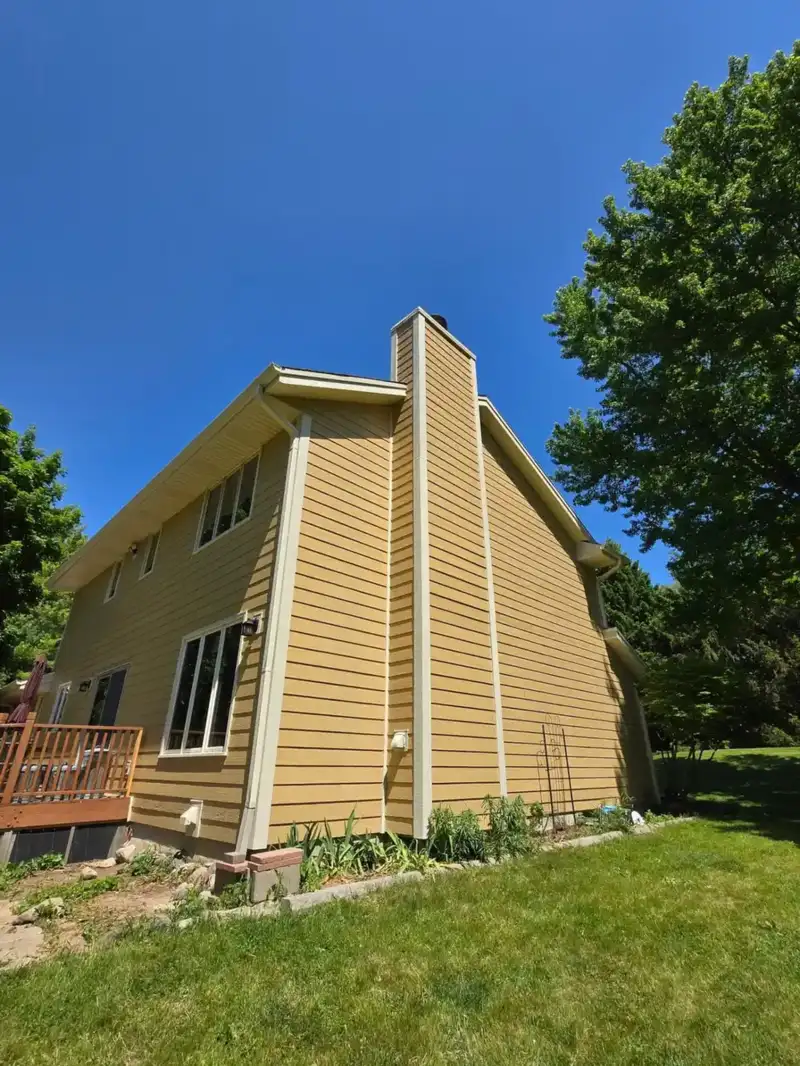 New yellow LP SmartSide siding and white trim on a Wisconsin two-story