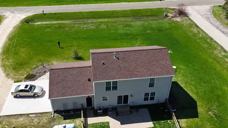 Aerial back view of a Wisconsin two-story home with a freshly installed brown architectural shingle roof