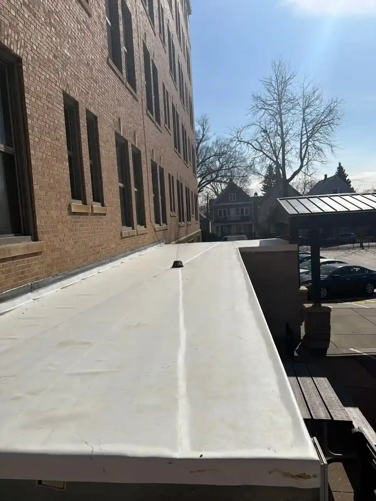 TPO white membrane flat roof installed on a downtown commercial building