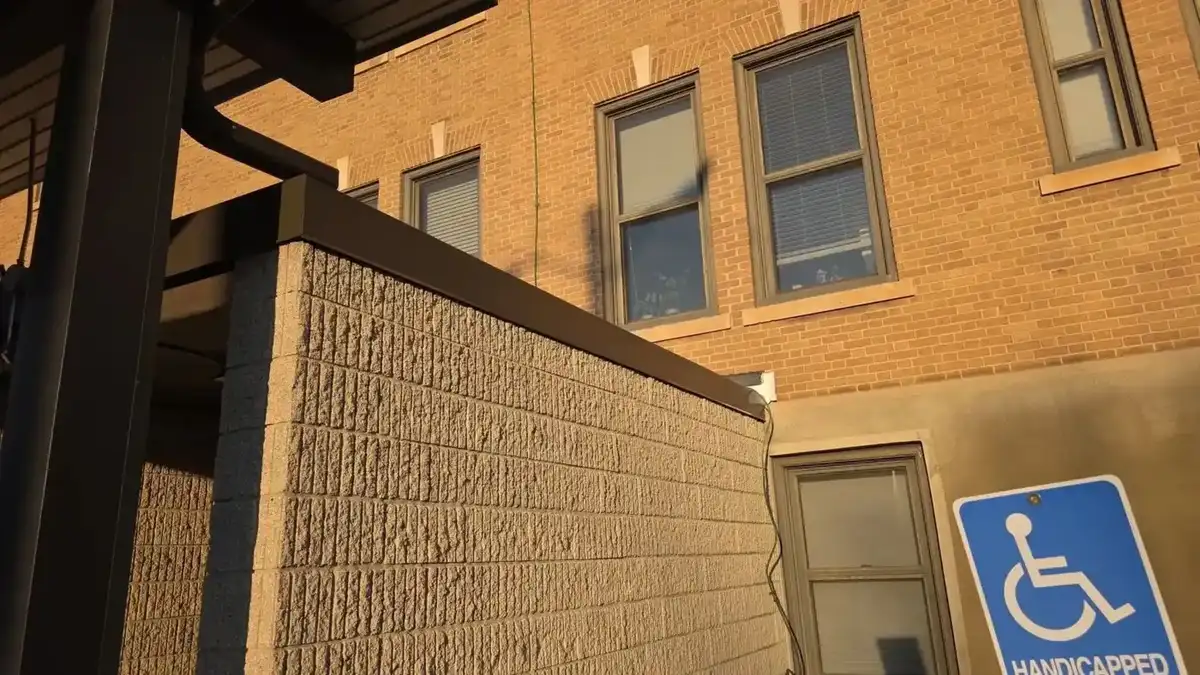 Brick commercial building with new metal coping cap and trim