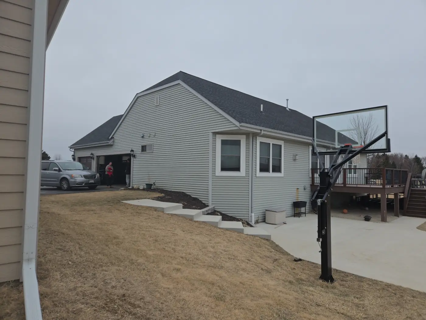 Before rear angle photo of a Richfield Wisconsin home with original siding and deck before exterior remodel