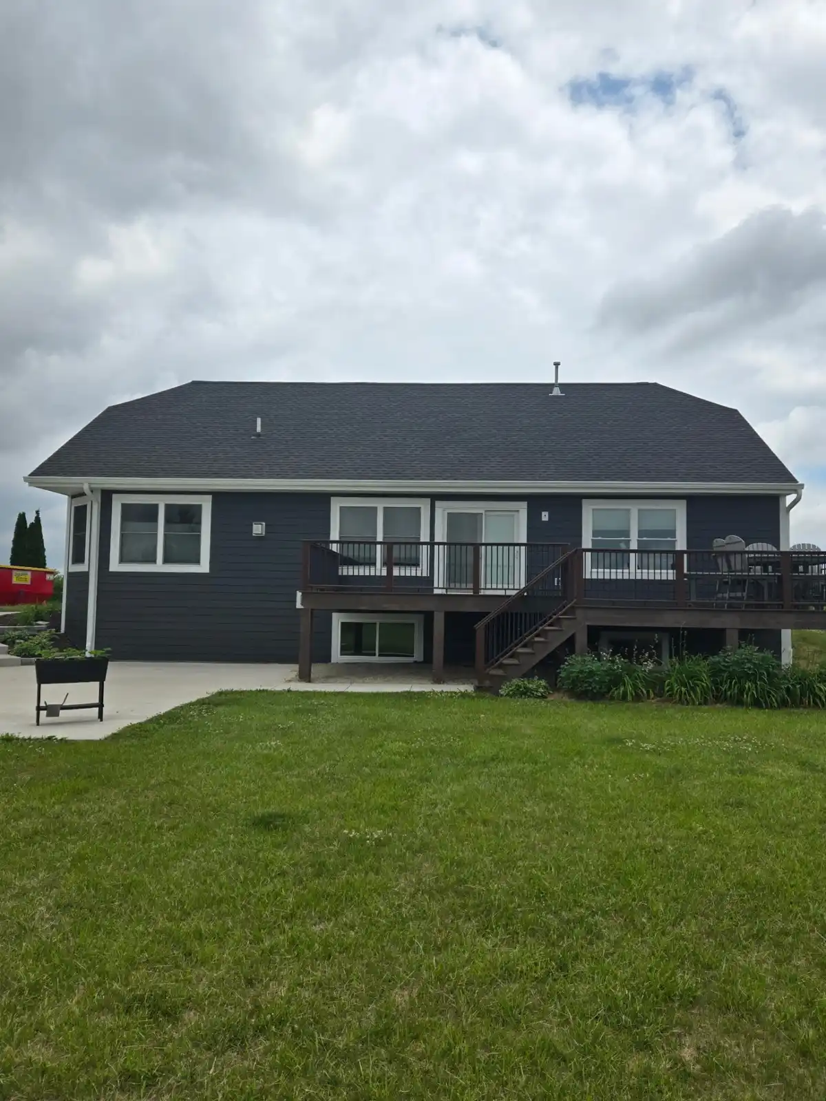 After rear elevation of a Richfield Wisconsin home with LP SmartSide siding and updated gutter system