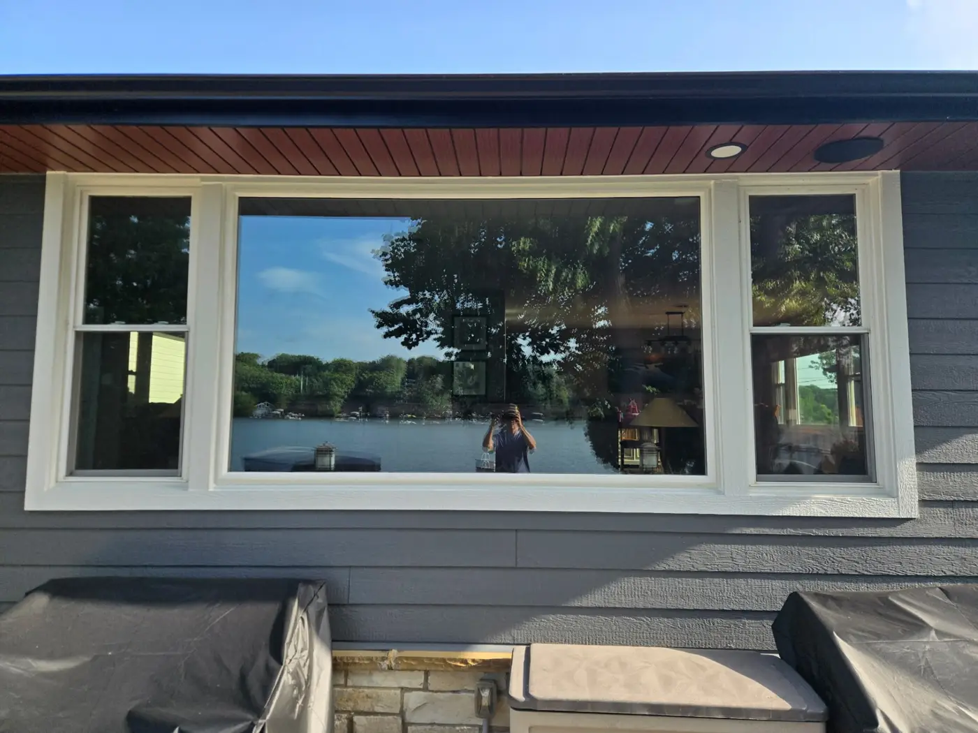 Large picture window on a gray LP SmartSide home with wood soffit