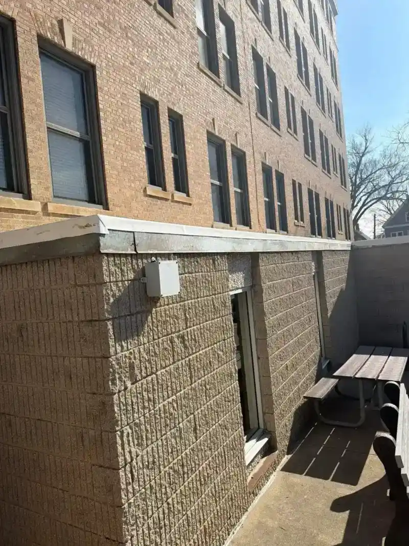 TPO flat roof with new black metal coping over a parking lot